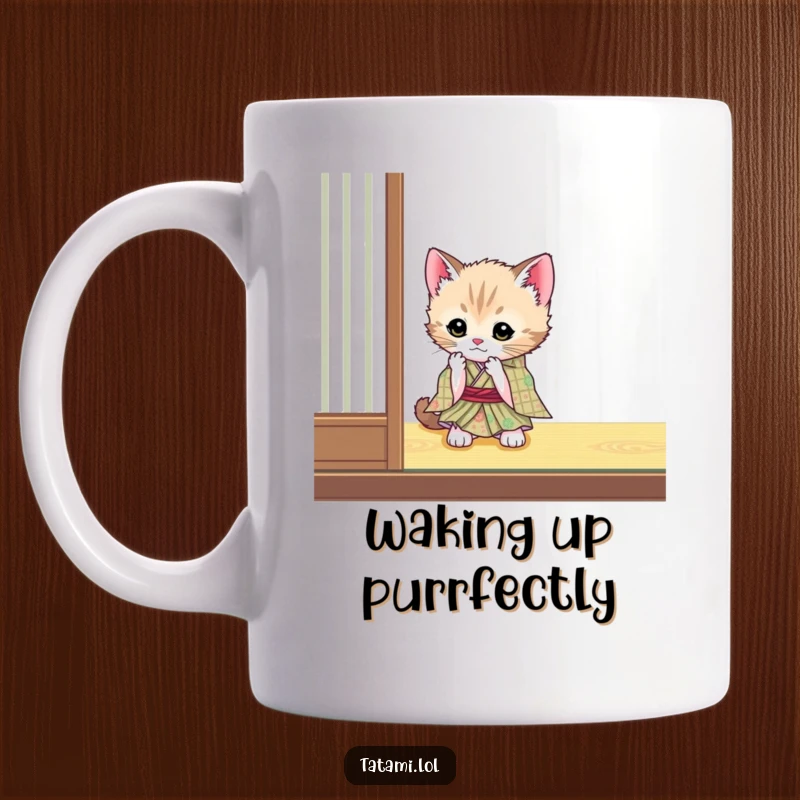 Funny cute kitten wearing a tiny kimono, playfully batting at a tatami mat corner on a mug.