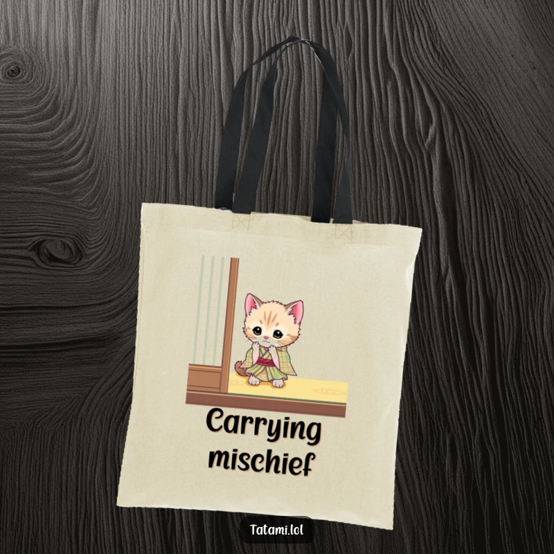 Funny kitten wearing a kimono on a tote bag, playfully batting a tatami mat, a cute and functional accessory.
